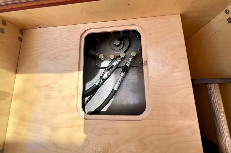 Kala Yacht Photos Pics Wooden compartment with visible hoses in a 2018 Nimbus 365 Coupe boat.