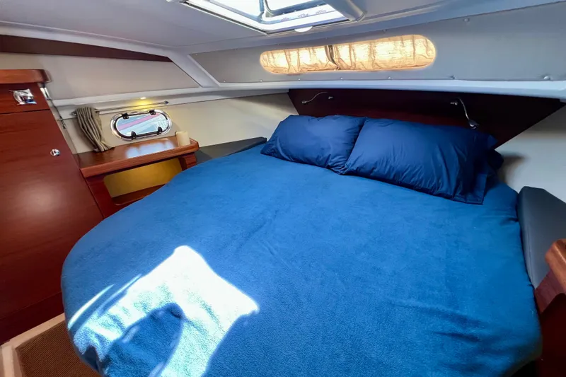 Kala Yacht Photos Pics Cozy cabin interior of 2018 Nimbus 365 Coupe with blue bedding and wooden accents.