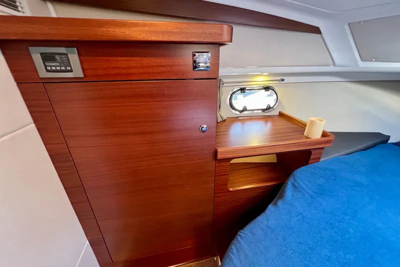 Kala Yacht Photos Pics Interior of 2018 Nimbus 365 Coupe with wooden cabinetry and cozy sleeping area.