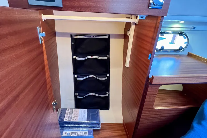 Kala Yacht Photos Pics Interior of 2018 Nimbus 365 Coupe showing wooden cabinetry and storage compartments.