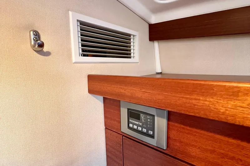 Kala Yacht Photos Pics Interior of 2018 Nimbus 365 Coupe featuring wooden paneling and a Dometic control panel.