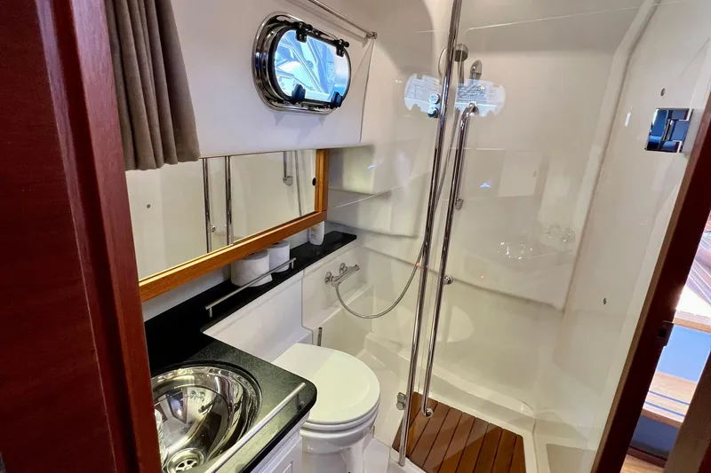 Kala Yacht Photos Pics Luxurious bathroom in 2018 Nimbus 365 Coupe yacht with modern fixtures and shower.