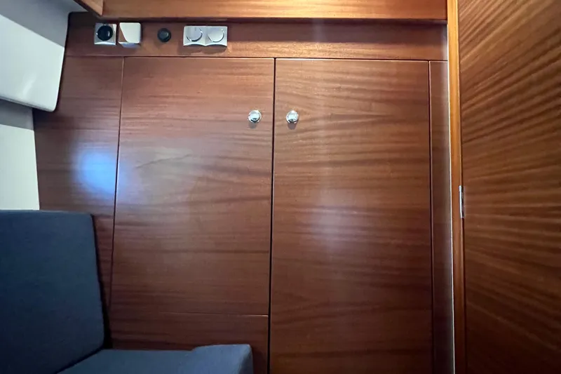 Kala Yacht Photos Pics Wooden interior of 2018 Nimbus 365 Coupe boat with seating and storage.