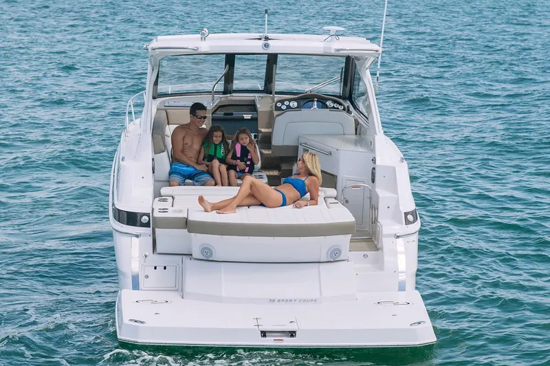 Popsicle Yacht Photos Pics 2019 Regal 35 Sport Coupe on the water with family relaxing on deck.