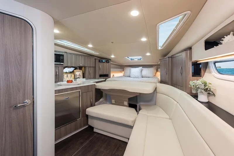 Popsicle Yacht Photos Pics Interior of 2019 Regal 35 Sport Coupe yacht with modern kitchen and cozy seating area.
