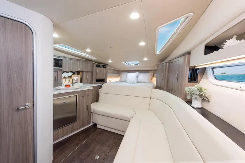 Popsicle Yacht Photos Pics Luxurious interior of 2019 Regal 35 Sport Coupe with modern kitchen and cozy seating.