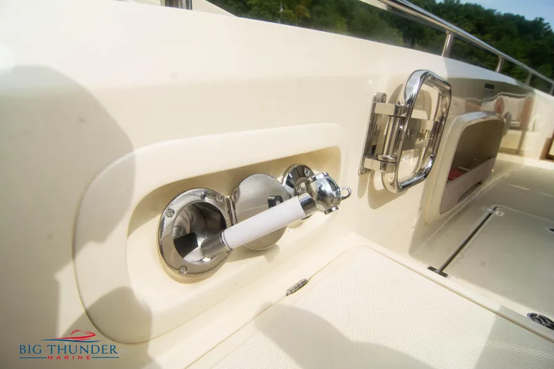  Yacht Photos Pics 2024 Invictus TT280S boat deck with chrome fixtures and storage compartment.