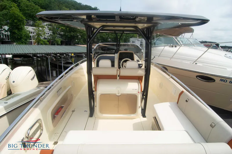  Yacht Photos Pics 2024 Invictus TT280S boat interior with seating and helm, docked at marina.