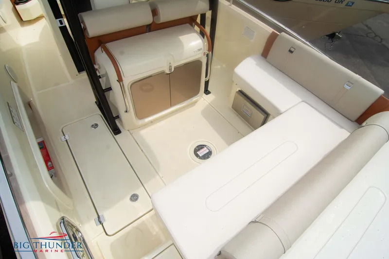  Yacht Photos Pics 2024 Invictus TT280S boat interior with beige seating and storage compartments.