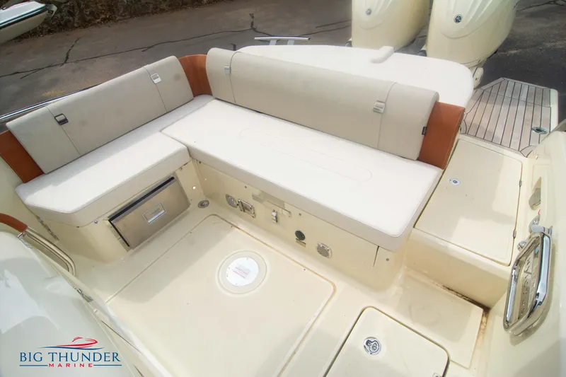  Yacht Photos Pics 2024 Invictus TT280S boat interior with beige seating and storage compartments.