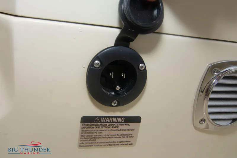  Yacht Photos Pics 2024 Invictus TT280S power socket with warning label and Big Thunder Marine logo.