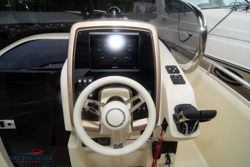  Yacht Photos Pics 2024 Invictus TT280S boat dashboard with steering wheel and Garmin display.