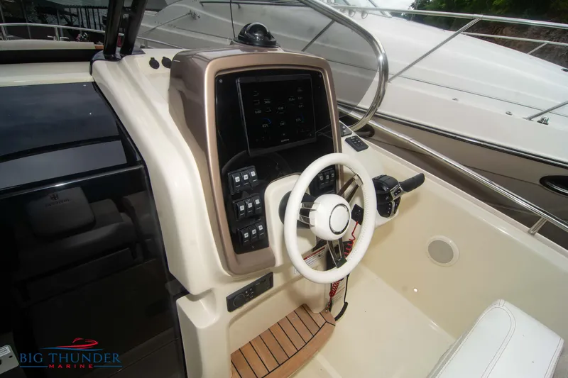  Yacht Photos Pics 2024 Invictus TT280S boat helm with modern controls and steering wheel.