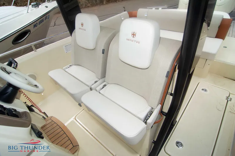  Yacht Photos Pics 2024 Invictus TT280S boat interior with dual seats and steering wheel.