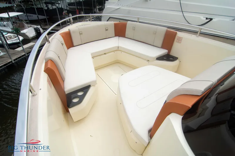  Yacht Photos Pics 2024 Invictus TT280S boat with spacious seating area and cup holders at a marina.