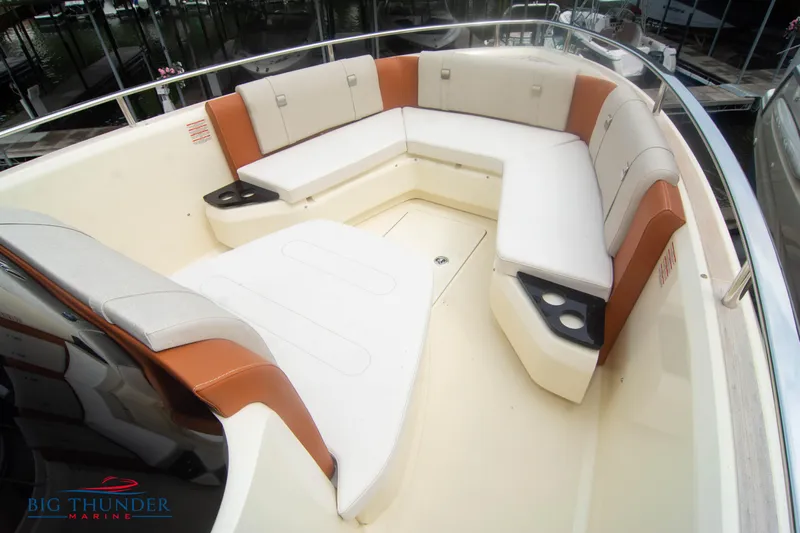  Yacht Photos Pics 2024 Invictus TT280S boat interior with white and brown seating, cup holders, and sleek design.