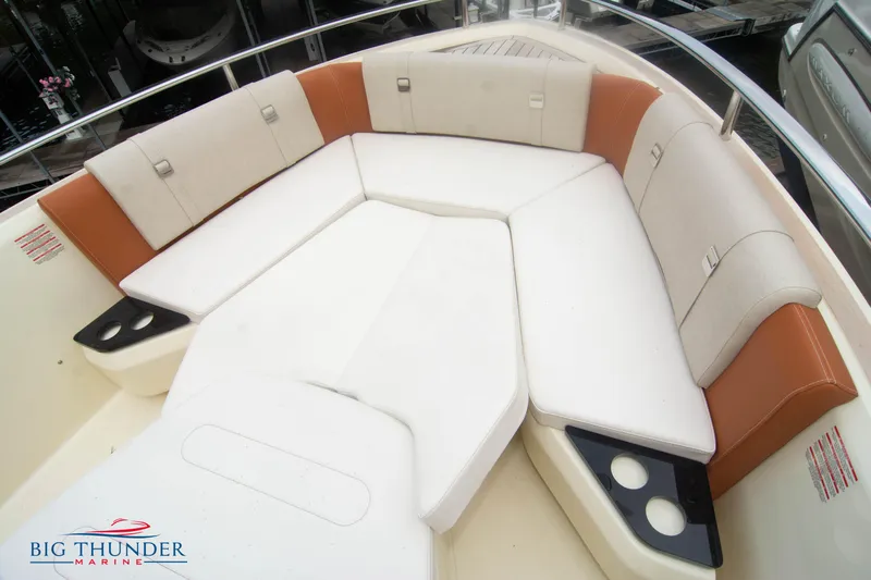  Yacht Photos Pics 2024 Invictus TT280S boat interior with cushioned seating and cup holders.
