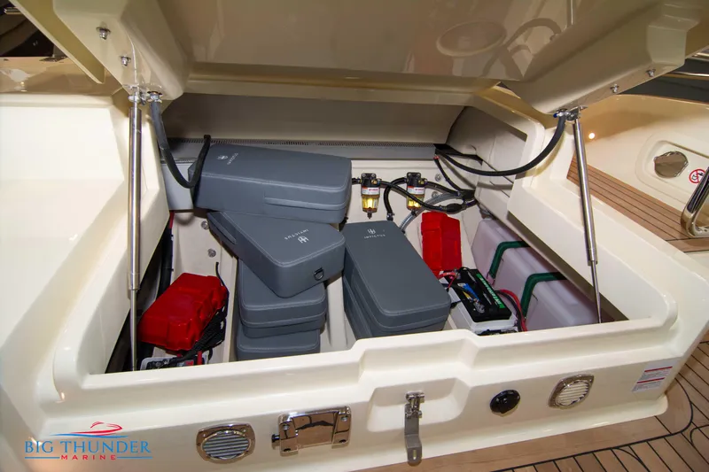  Yacht Photos Pics 2024 Invictus TT280S engine compartment with batteries and wiring, showcasing marine engineering.