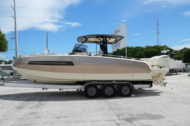  Yacht Photos Pics 2024 Invictus TT280S boat on trailer, sleek design, outdoor display.