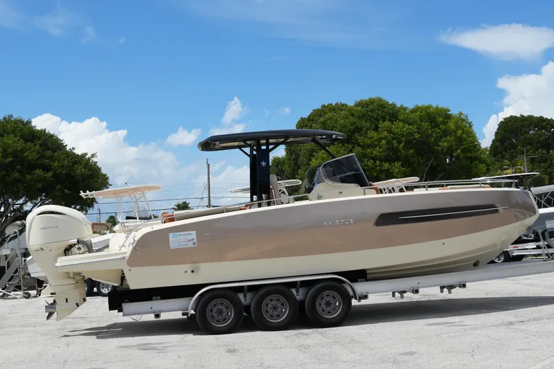  Yacht Photos Pics 2024 Invictus TT280S boat on trailer under clear blue sky.