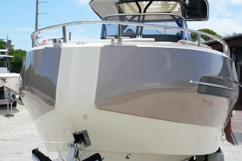  Yacht Photos Pics 2024 Invictus TT280S boat front view, sleek design, docked outdoors.