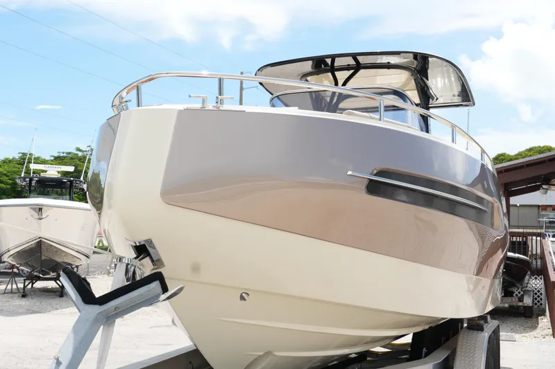  Yacht Photos Pics 2024 Invictus TT280S boat on trailer, sleek design, outdoor display.