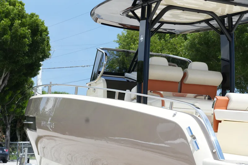  Yacht Photos Pics 2024 Invictus TT280S luxury boat with sleek design and comfortable seating.
