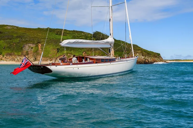 Gwenhyfar II Yacht Photos Pics 2023 Spirit Yachts C72 sailing near a scenic coastline with clear blue waters.