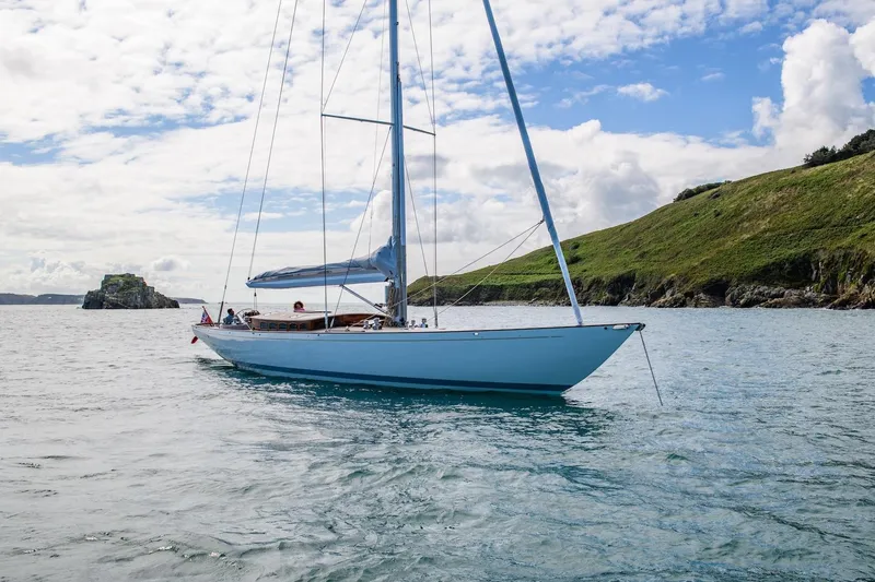 Gwenhyfar II Yacht Photos Pics 2023 Spirit Yachts C72 sailing on calm waters near a lush green coastline.