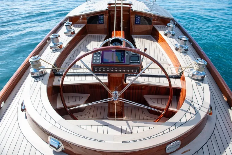 Gwenhyfar II Yacht Photos Pics 2023 Spirit Yachts C72 cockpit with wooden deck and steering wheel on open water.