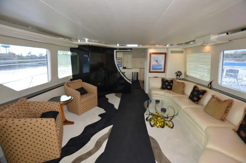 Reel Life Yacht Photos Pics Luxurious interior of 1996 Hatteras 82 Convertible yacht with elegant seating and decor.