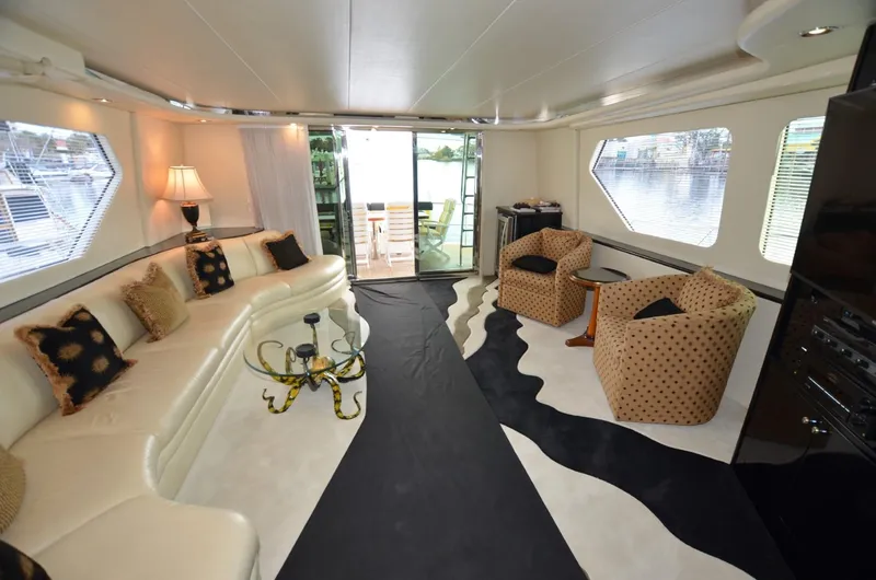 Reel Life Yacht Photos Pics Luxurious interior of 1996 Hatteras 82 Convertible yacht with elegant seating and decor.