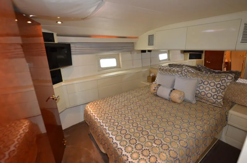 Reel Life Yacht Photos Pics Luxurious bedroom interior of 1996 Hatteras 82 Convertible yacht with elegant bedding.