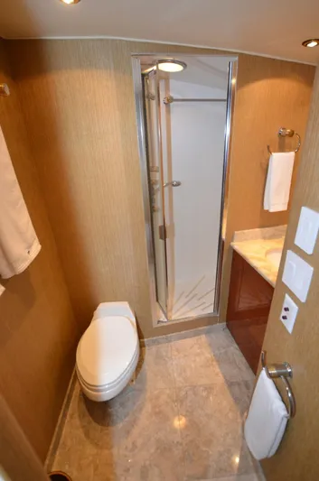 Reel Life Yacht Photos Pics Luxurious bathroom in 1996 Hatteras 82 Convertible yacht with shower and modern fixtures.