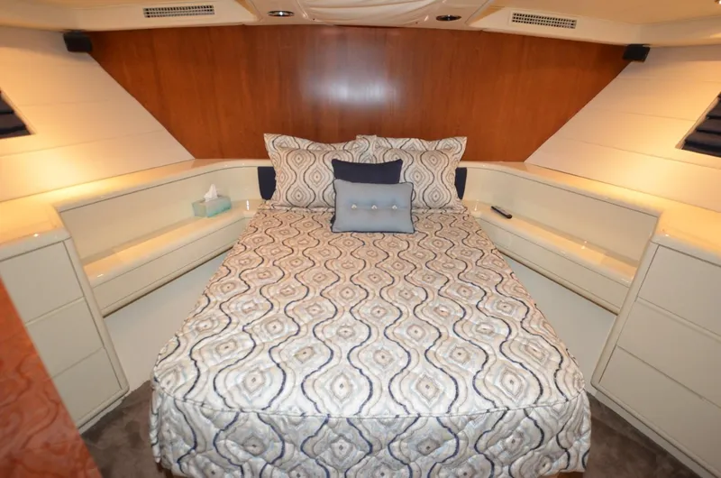 Reel Life Yacht Photos Pics Luxurious bedroom interior of 1996 Hatteras 82 Convertible yacht with patterned bedding.