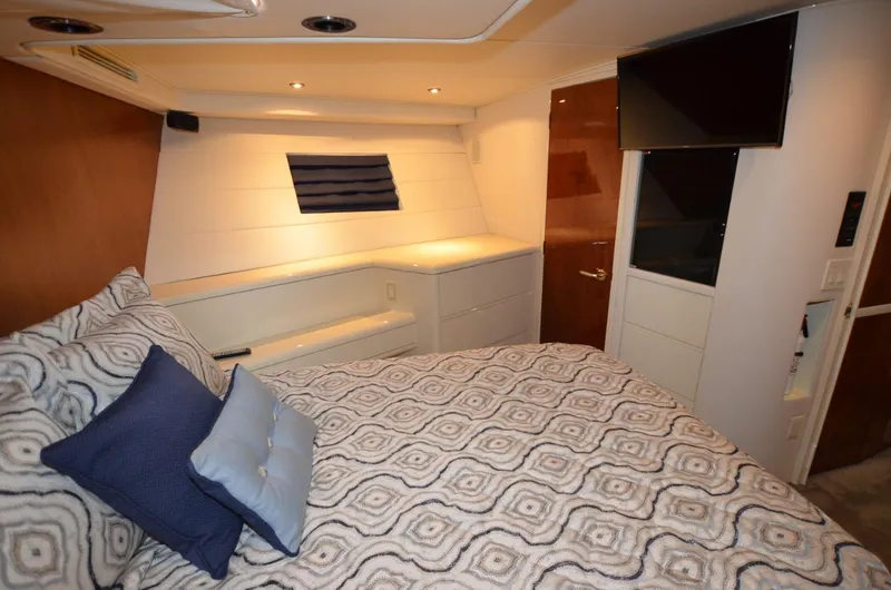 Reel Life Yacht Photos Pics Luxurious bedroom interior of 1996 Hatteras 82 Convertible yacht with modern decor.
