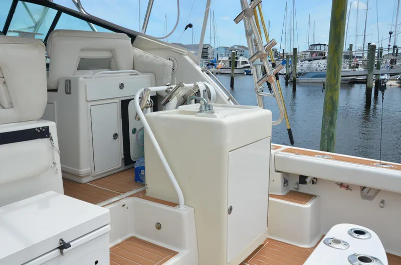 Double Trouble Yacht Photos Pics 1992 Tiara Yachts 43 Open interior with marina view, featuring seating and storage.