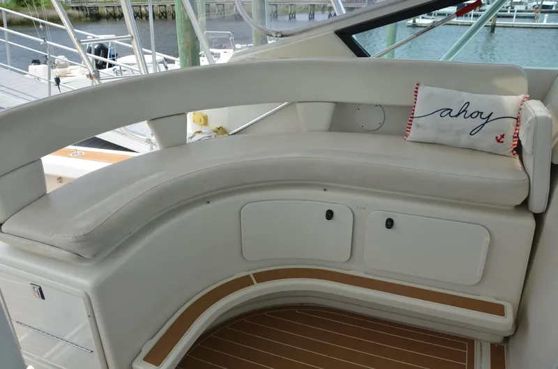 Double Trouble Yacht Photos Pics 1992 Tiara Yachts 43 Open interior with curved seating and "ahoy" pillow.