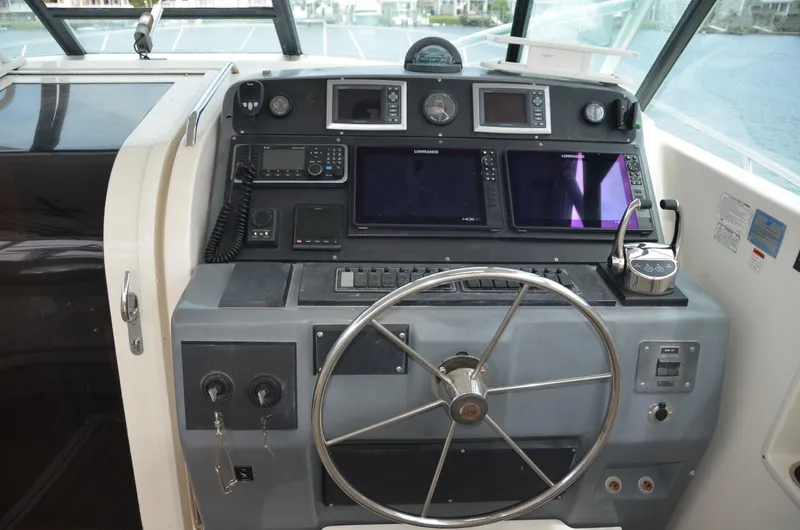 Double Trouble Yacht Photos Pics 1992 Tiara Yachts 43 Open helm with navigation instruments and steering wheel.