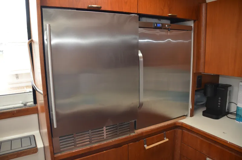 Double Trouble Yacht Photos Pics Stainless steel refrigerator in 1992 Tiara Yachts 43 Open kitchen area.