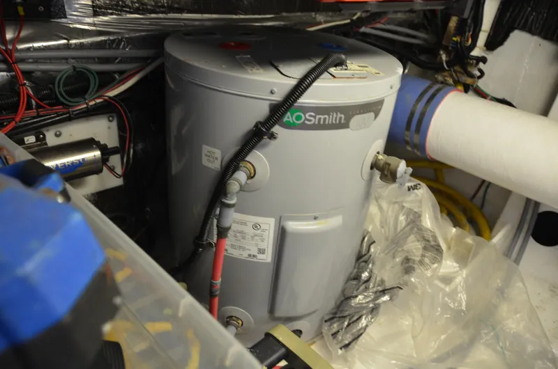 Double Trouble Yacht Photos Pics Water heater in 1992 Tiara Yachts 43 Open engine room, surrounded by wiring and equipment.