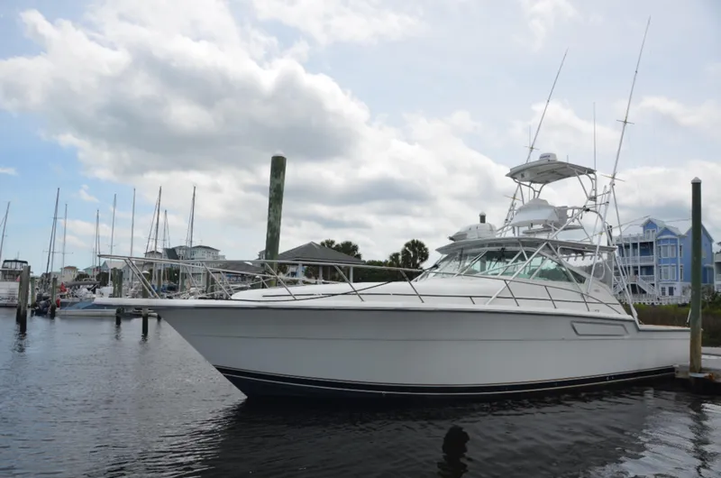 Double Trouble Yacht Photos Pics 1992 Tiara Yachts 43 Open docked at a marina under cloudy skies.