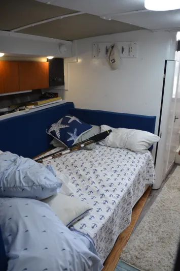 Double Trouble Yacht Photos Pics Cozy cabin interior of 1992 Tiara Yachts 43 Open with nautical-themed bedding.