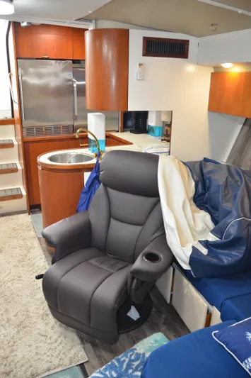 Double Trouble Yacht Photos Pics Interior of 1992 Tiara Yachts 43 Open with leather chair and modern kitchen amenities.