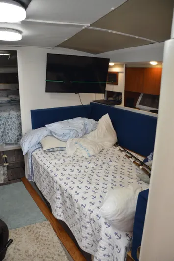 Double Trouble Yacht Photos Pics Interior of 1992 Tiara Yachts 43 Open with cozy bedding and modern TV setup.