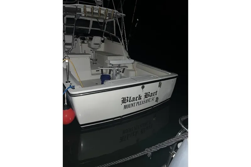 Black Bart Yacht Photos Pics 1998 Henriques 28 Express boat docked at night, named "Black Bart," Mount Pleasant, SC.