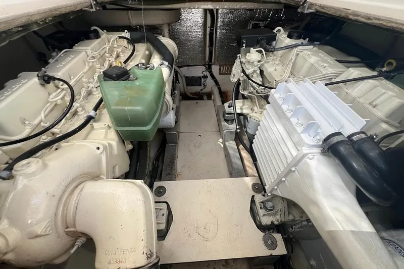 Black Bart Yacht Photos Pics Engine compartment of a 1998 Henriques 28 Express boat, showcasing dual engines and components.