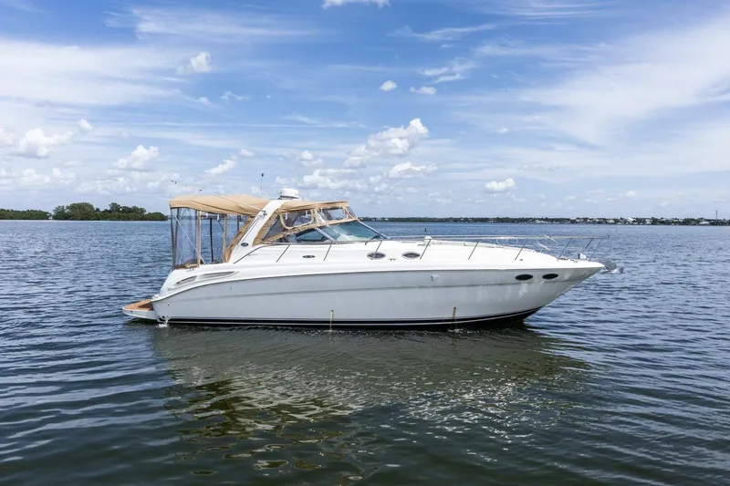  Yacht Photos Pics 2001 Sea Ray 380 Sundancer yacht on calm water under a clear blue sky.