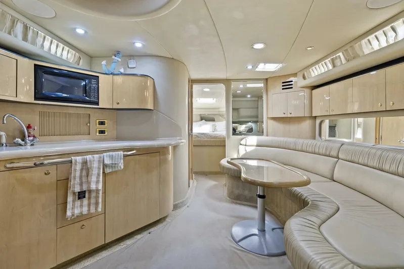  Yacht Photos Pics Luxurious interior of 2001 Sea Ray 380 Sundancer yacht with kitchen and seating area.