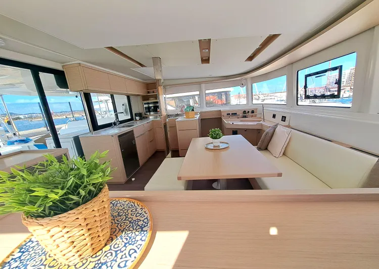  Yacht Photos Pics Luxurious interior of 2023 Lagoon 46 catamaran with modern kitchen and dining area.